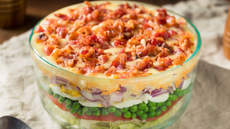 Seven-layer salad in glass bowl