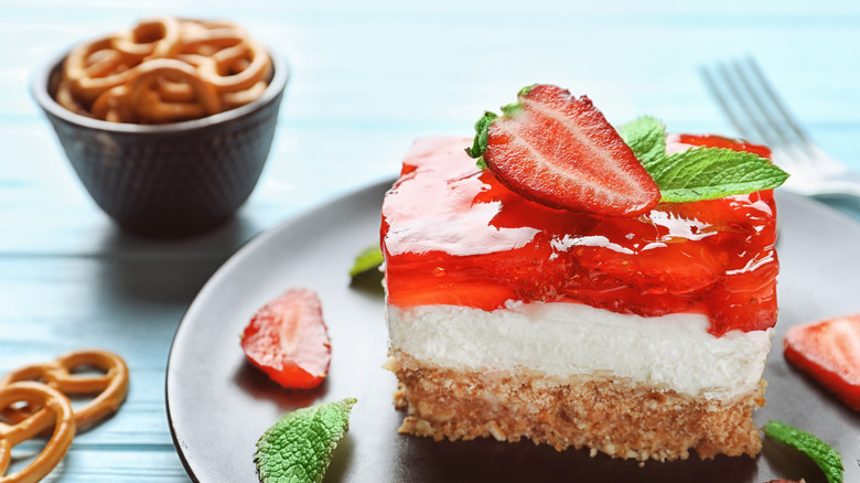 Slice of strawberry pretzel salad on plate