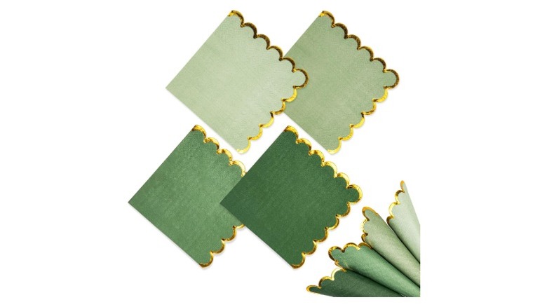 Scalloped napkins in varying green shades with gold trimmings