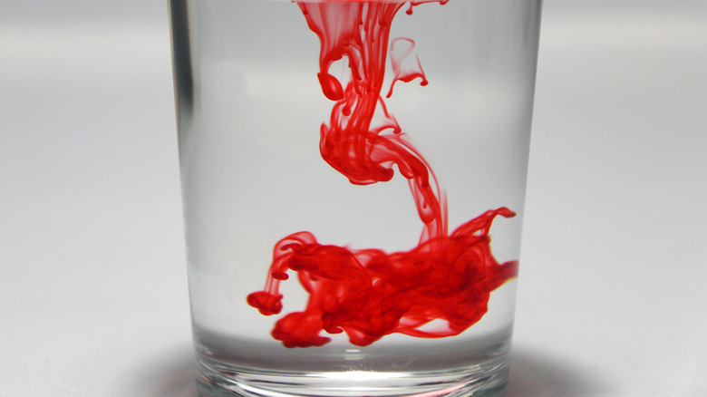 Red dye in glass of water