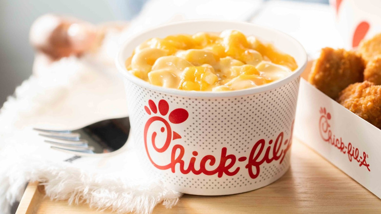 bowl of chick-fil-a mac and cheese next to box of chicken
