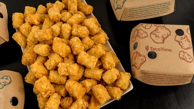 A large portion of Taco Time Mexi-Fries sits on a black table