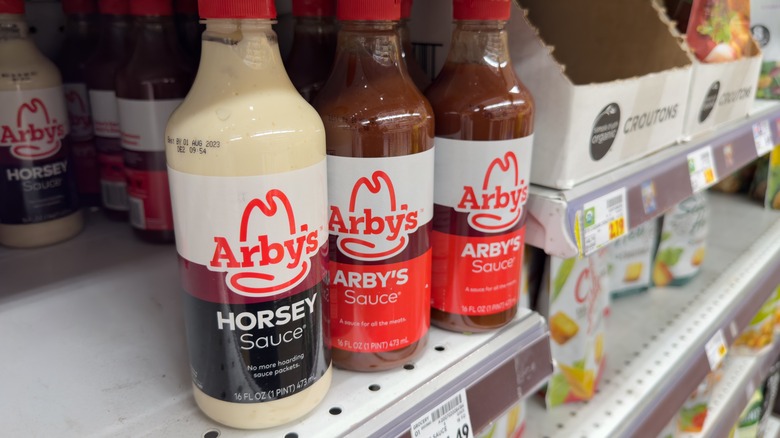 Various Arby's sauces on a grocery shelf
