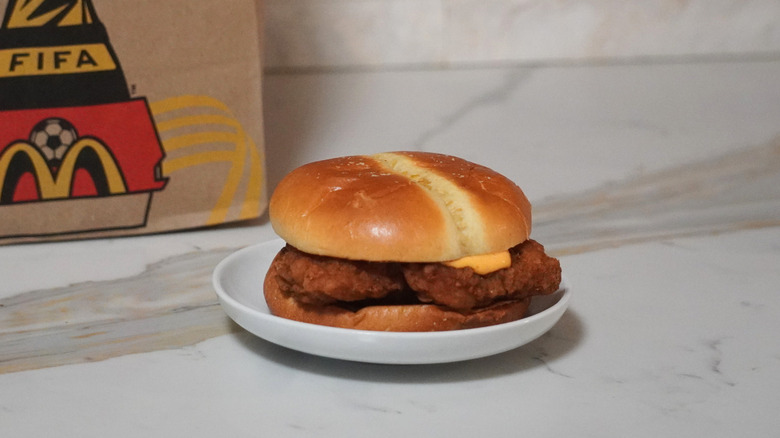 McDonald's Spicy McCrispy in front of a McDonald's brown paper bag.
