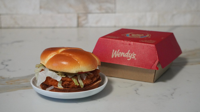 Wendy's Spicy Chicken Sandwich in front of a red Wendy's box.