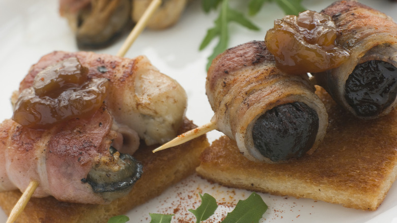 Devils on horseback and angels on horseback atop crackers