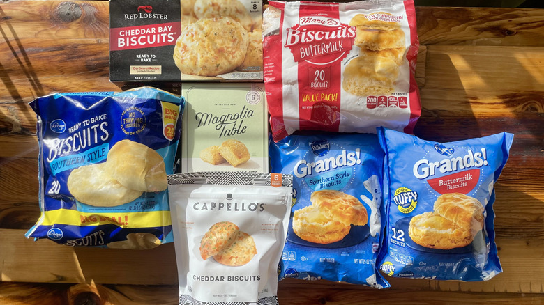 Overhead view of various bags of frozen biscuits on wooden tabletop