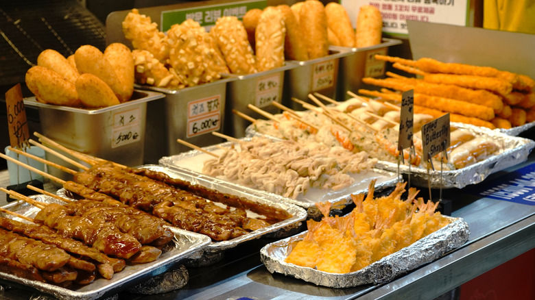 Several pans of Korean street food in a stall