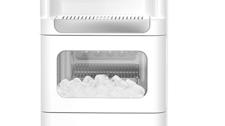 The ice container full of ice on the Electastic water dispenser and ice maker combination machine