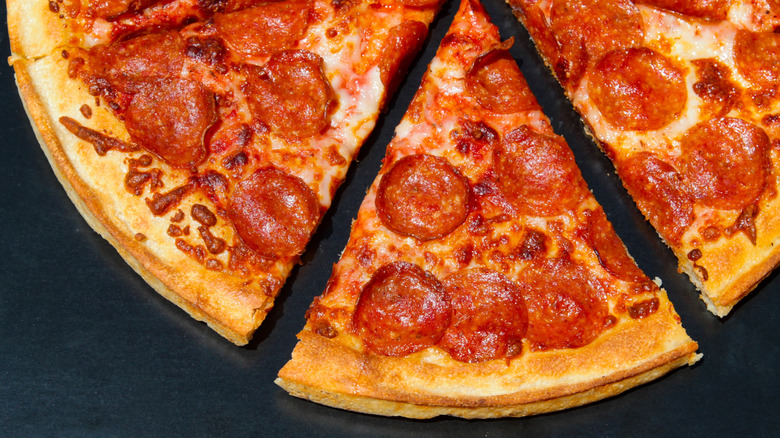 Slices of glistening pepperoni pizza