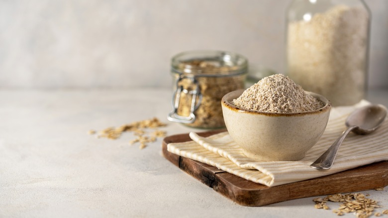 Oat flour in a bowl with a spoon and napkin