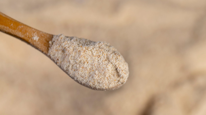 Whole wheat flour in a wooden spoon