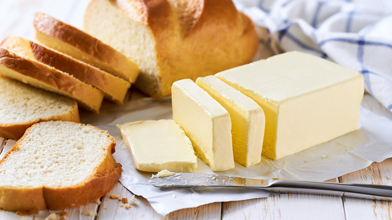 Sliced butter and sliced bread.