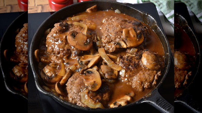 salisbury steaks in a cast iron pan