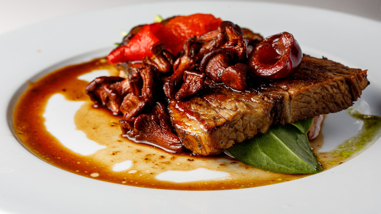 steak Diane on a white plate