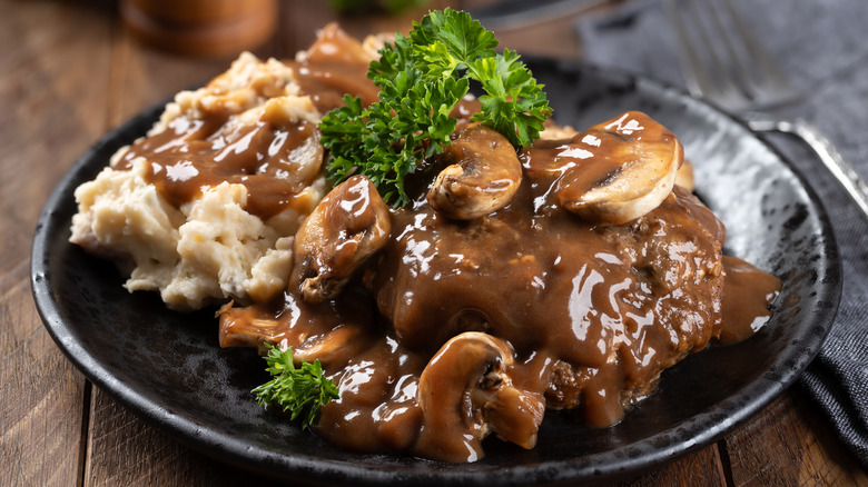 salisbury steak with mushrooms garnished with parsley