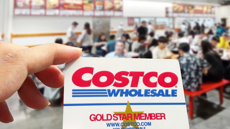 Costco membership card with food court in the background