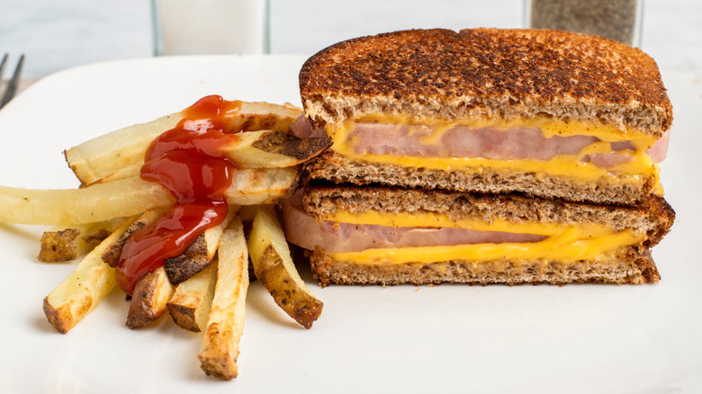 A toasted SPAM and cheese sandwich served with fries and ketchup