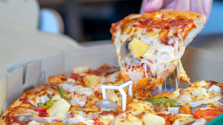 Slice of pizza with pineapple tidbits