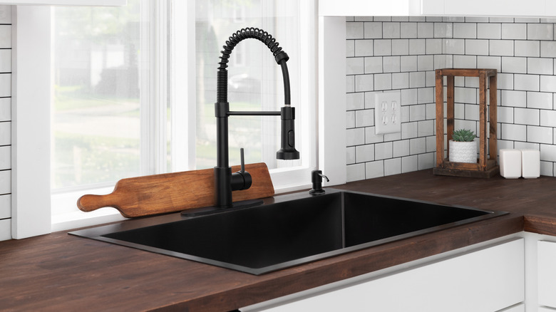 Subway-tile backsplash in kitchen with wooden countertops