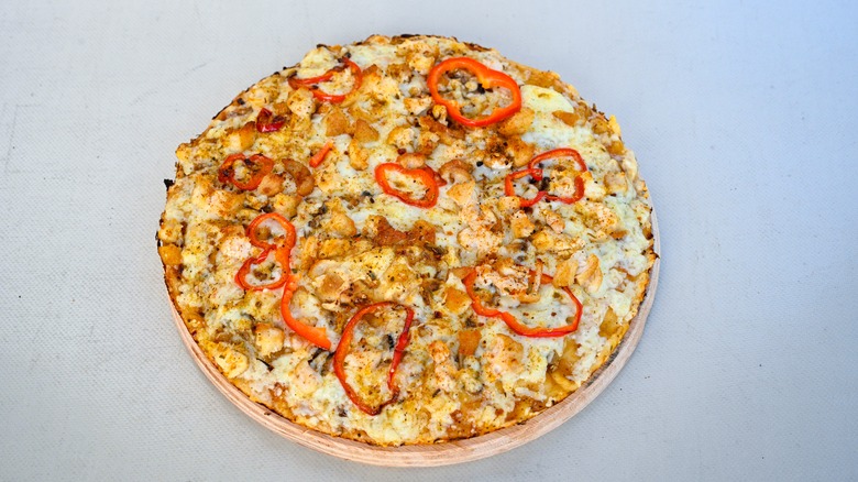 Mediterranean pizza with chicken, peppers, and hummus