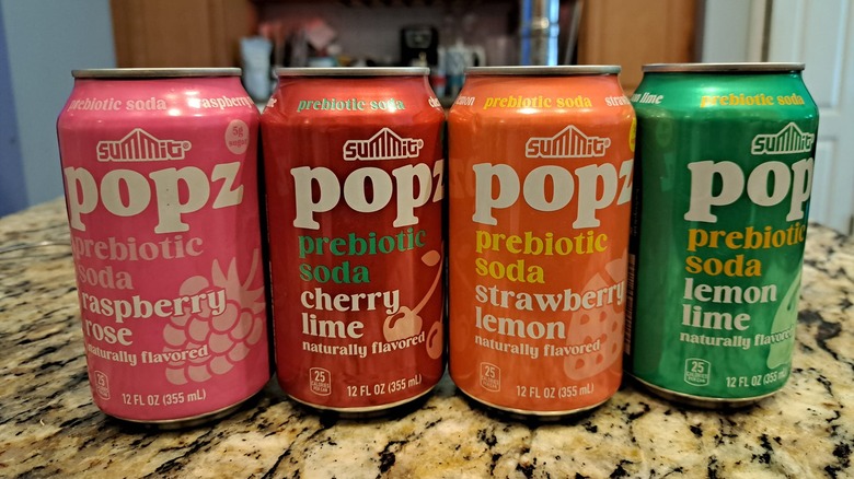Four cans of Aldi's Summit Popz Prebiotic Sodas on a kitchen counter