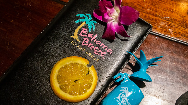 Closeup of a bill case with the Bahama Breeze Island Grille logo on it