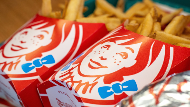 Closeup of two Wendy's orders of fries in branded fry boxes
