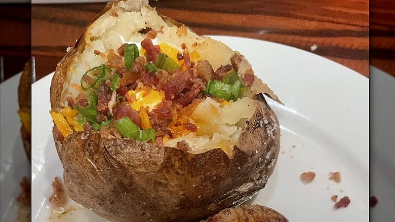 Closeup of a loaded baked potato at LongHorn Steakhouse