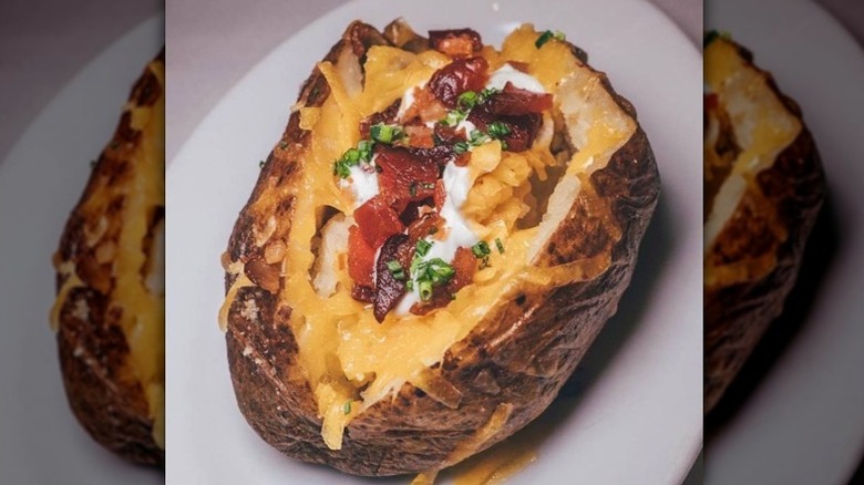 Closeup of a loaded baked potato from Ocean Prime