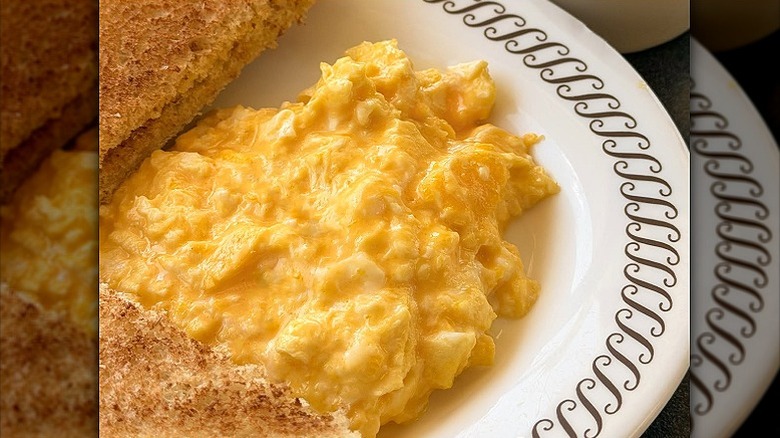Closeup of a plate of cheesy scramble eggs and wheat toast at Waffle House