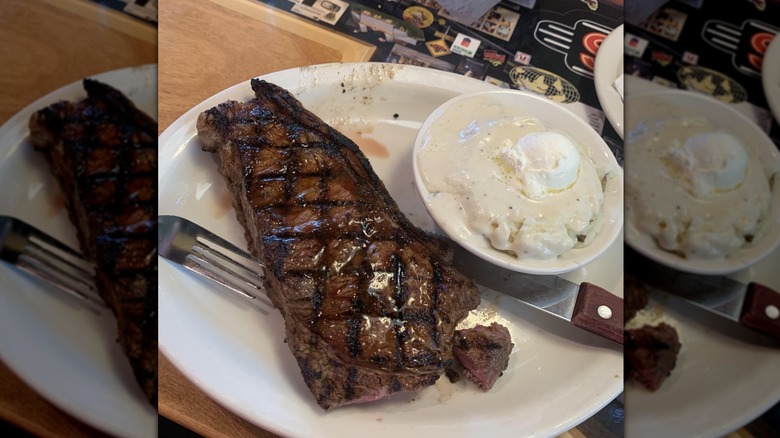 A New York strip steak with grill marks sits next to side Texas Roadhouse