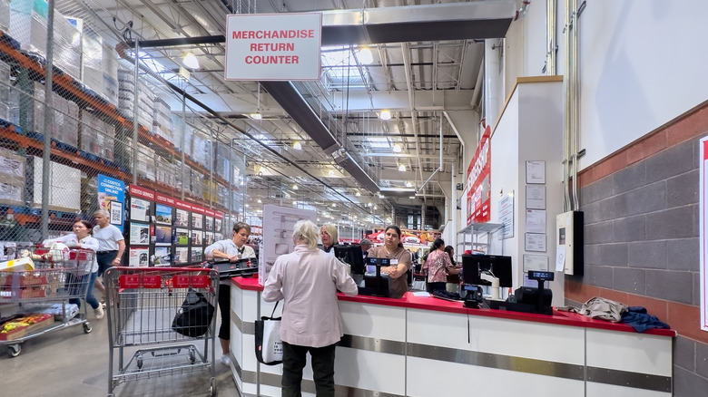 Customers being helped at a Costco return counter