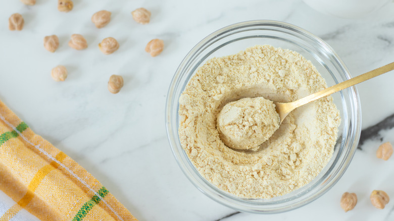 Overhead view of a glass bowl full of chickpea flour