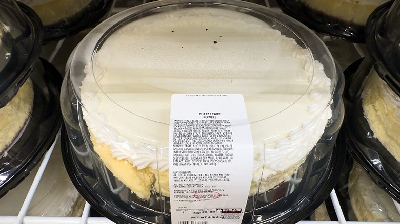 A broken cheesecake sits on a shelf at a Costco bakery
