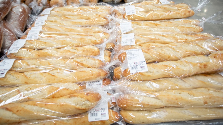 Packages of French bread lie on a table in a Costco bakery