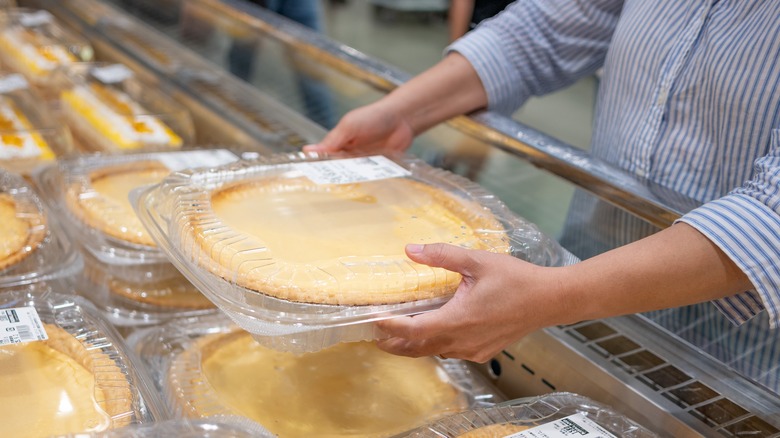 Person holding Costco pie.