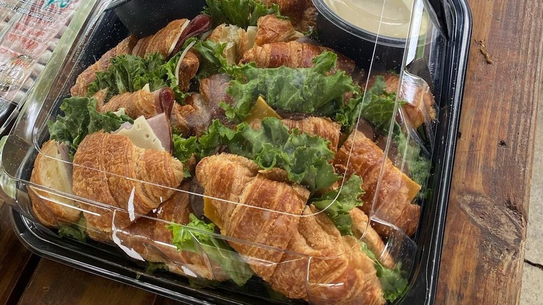 A box of Costco Kirkland croissant sandwiches with various sauces