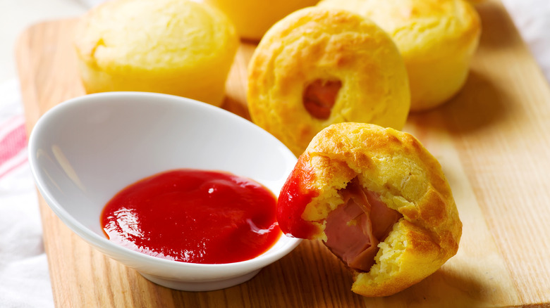 Corn dog muffins next to ketchup