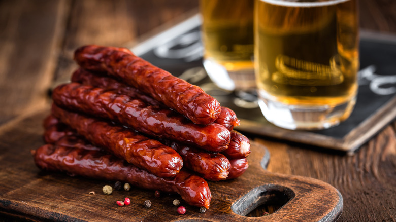 Hot dogs next to pints of light beer