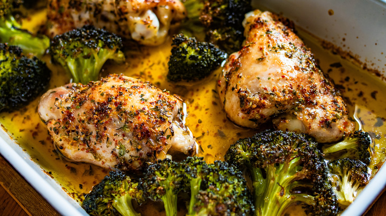 Baking dish full of seasoned chicken and broccoli florets