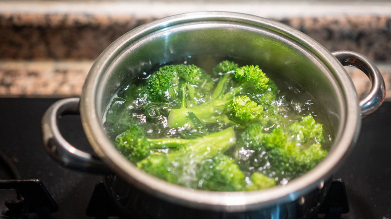 Pot of boiling water with broccoli florets