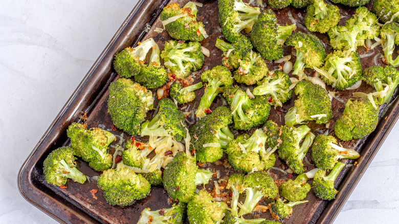 Baking tray full of roasted broccoli florets