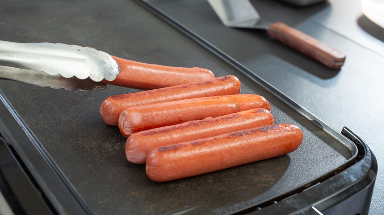Hot dogs on a flat-top griddle