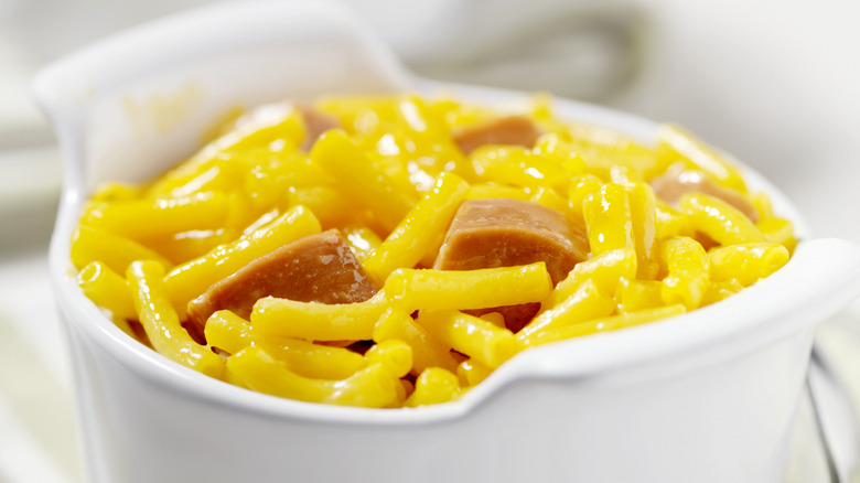 Sliced hot dogs in mac and cheese in ramekin