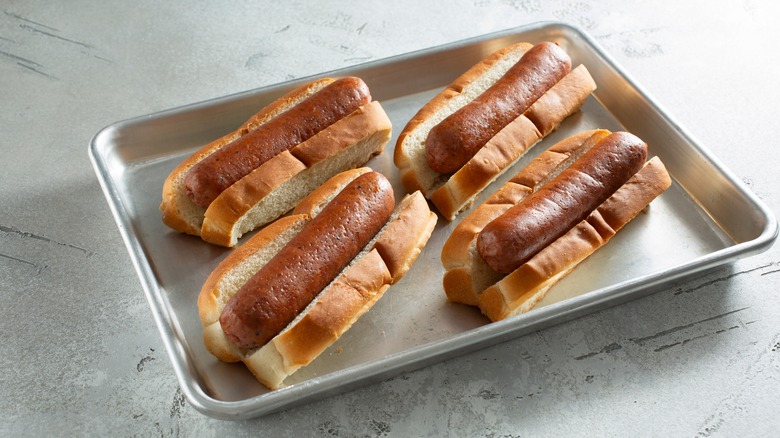 hot dogs on bread slices in a metal baking tray
