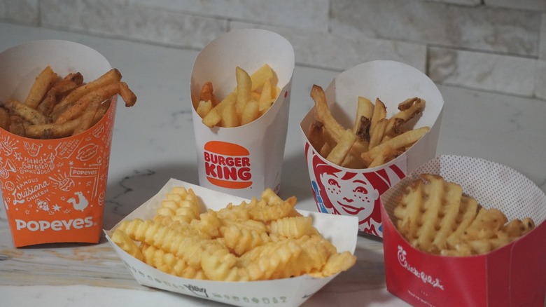 Side view of French fries from Popeyes, Burger King, Shake Shack, Wendy's, and Chick-fil-A (left to right).