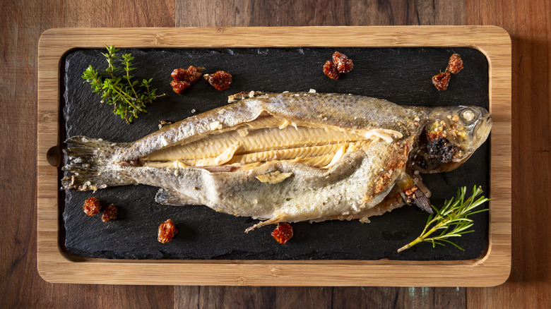 baked rainbow trout on slate board