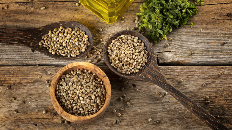 Hemp seeds in rustic bowls and spoons.