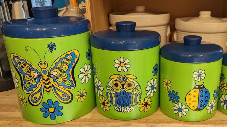 three nesting canisters with green and blue psychedelic art